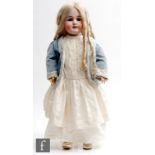 A Gebrüder Kühnlenz bisque socket head doll with fixed blue paperweight eyes, open mouth with teeth,