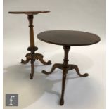 A mahogany supper table in the George III style, the circular top above a turned pedestal and tripod
