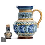 A late 19th Century Doulton Lambeth stoneware jug decorated with applied raised repeat patterns in