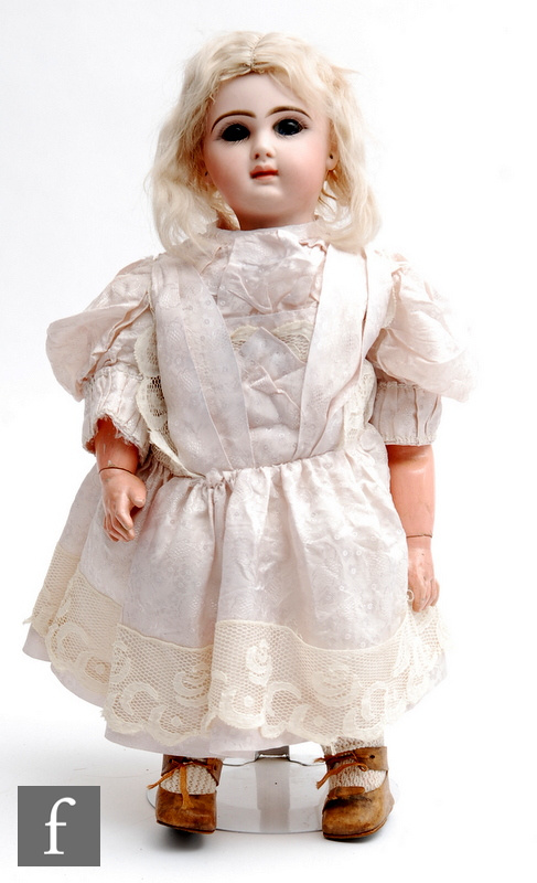 An unmarked French bisque head doll, probably Jumeau, with fixed blue paperweight eyes, painted