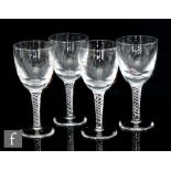 Robert Welch - A set of four air twist wine glasses, the round funnel bowl above a four strand air