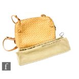 Bottega Veneta - A tan intrecciato leather cross body bag, with loop and strap handle, suede lined