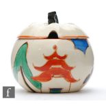 Clarice Cliff - Kew - An apple shaped preserve pot and cover circa 1931, hand painted with a
