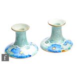 Grays Pottery - A pair of 1930s squat candlesticks decorated with hand painted flowers with sponging