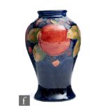 William Moorcroft - A vase of inverted baluster form decorated in the Pomegranate pattern with a