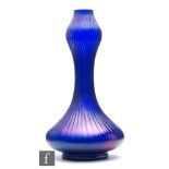 Kralik - An early 20th Century ribbed glass vase of footed low shouldered form with tall swollen