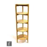 Ercol Furniture - A light oak five-tier circular shelving unit on triangular shaped frame, height