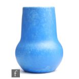 Ruskin Pottery - A vase of globe and shaft form decorated in an all over mottled blue, impressed