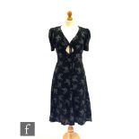 Ossie Clark - Radley - A black moss crepe midi dress with a white Paisley type print, the bust