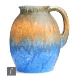 Ruskin Pottery - A crystalline glazed flower jug decorated in a streaked and dribble green to orange