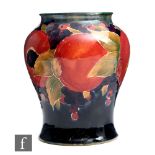 William Moorcroft - A jar form vase decorated in the Pomegranate pattern with a band of open and