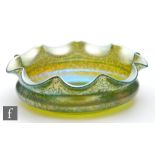 Loetz - A large early 20th Century glass bowl of shallow circular form with a deep wave rim,