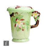 Carlton Ware - An embossed chocolate cup and cover decorated in the Apple Blossom pattern, printed