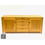 Ercol Furniture - A light oak Bosco range sideboard fitted with a central bank of four drawers