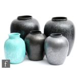 Poole Pottery - Five vases of assorted form comprising three with a black speckled glaze, one in