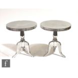 Eichholtz - A pair of 'Nantucket M' polished aluminium side tables, the rounded top on a tripod