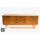 Unknown - A 1960s teak 'Long Tom' style sideboard, fitted with a central bank of three drawers