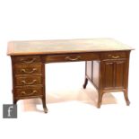 Unknown - A French Art Nouveau walnut desk with inset leather writing surface, fitted with an
