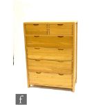 Ercol Furniture - A light oak Bosco range chest of two short over four long drawers, with curved