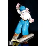 Tarcisio Tosin - A 1930s / 1950s Art Deco Italian pottery model of a skiier in blue trousers, a