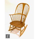 Lucian Ercolani for Ercol Furniture - A light elm and beech rocking chair, bears blue foil label,