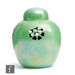 Ruskin Pottery - A small pot pourri and cover decorated in an apple green lustre with pierced flower