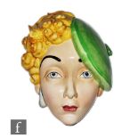 Beswick Pottery - A 1930s Art Deco face mask modelled as a young girl with curled blonde hair and