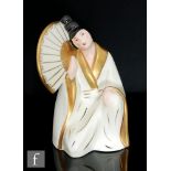 Limoges - A 1930s French Art Deco model of a kneeling lady in Japanese dress holding a fan,