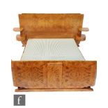 Georges & Gaston Guerin - An Art Deco French burr walnut veneered double bed with an arched head and