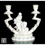Hutschenreuther - A 1930s Art Deco twin branch candelabra modelled as a lady kneeling to stroke a