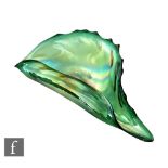 John Ditchfield - A later 20th Century studio glass bowl of shell form in a green iridescence,