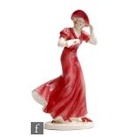 Czechoslovakian - A 1930s Art Deco model of a slightly windswept lady dressed in pink with white