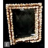 In the manner of Anthony Redmile - A 1970s shell encrusted wall mirror of rectangular form, with