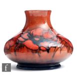 William Moorcroft - A vase of compressed form decorated in the Flambe Anemone pattern, impressed