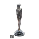 Unknown - An Art Deco silvered spelter figure modelled as a coquettish female nude, raised to a