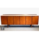 Robert Heritage for Archie Shine - A teak sideboard with a shallow ledge back above three double