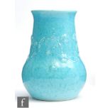 Ruskin Pottery - A large souffle glazed vase decorated with an applied and tubed band of flowers,