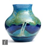 William Moorcroft - A small vase of compressed form decorated in the Moonlit Blue pattern, impressed