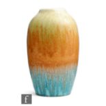 Ruskin Pottery - A crystalline vase of swollen form decorated in a streaked yellow to orange to blue