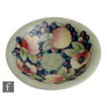 William Moorcroft - A 1930s bowl decorated in the Pomegranate pattern with open and whole fruits and