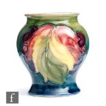 William Moorcroft - A small vase of inverted baluster form decorated in the Leaf and Berry