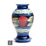 William Moorcroft - A small vase of inverted baluster form decorated in the Banded Pomegranate