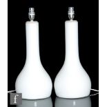 Iittala - A pair of glass table lamps, each of globe and shaft form, opal cased in clear, height