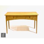 Heal's - A contemporary light oak desk or side table, fitted with three frieze drawers with