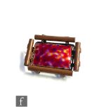 Jean Aguis - A copper and enamel brooch, rectangular red enamel panel within tubular copper borders,