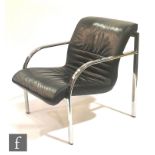 Dauphin Furniture, Germany - A black leather armchair with chromium plated flattened tubular