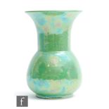 Ruskin Pottery - An apple green lustre vase of mallet form with a flared neck, impressed mark,