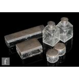 Unknown - A dressing table set with six clear crystal jars of varying form with white metal mounts