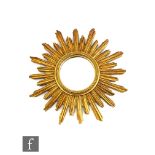 Unknown - A gilt metal sunburst mirror, circa 1970s, the central circular mirror plate with two