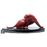 Paul Milet - Sevres - A 1930s Art Deco model of a snarling big cat, glazed in red on a black oval
